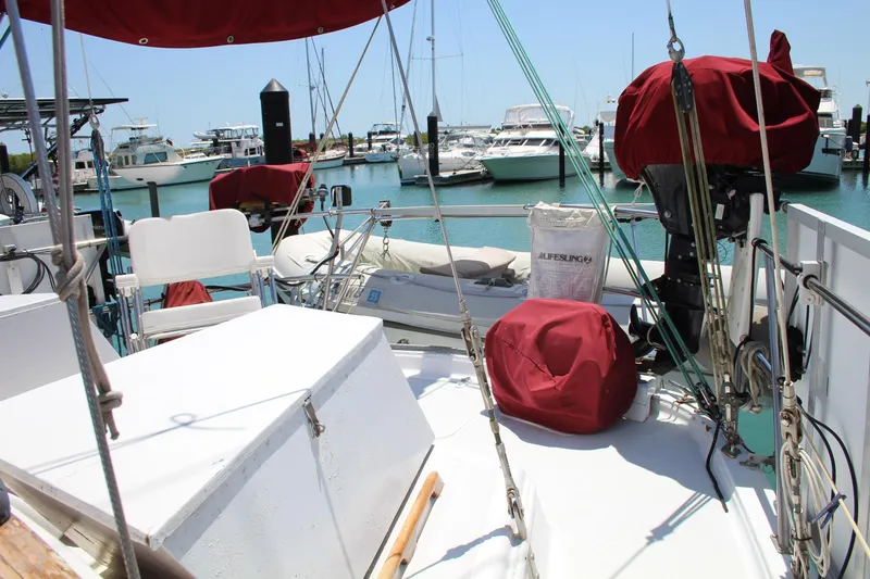 Slide: The Image of Sailboat Endeavour 43, 1981 model, docked in a marina with covered equipment. - 29