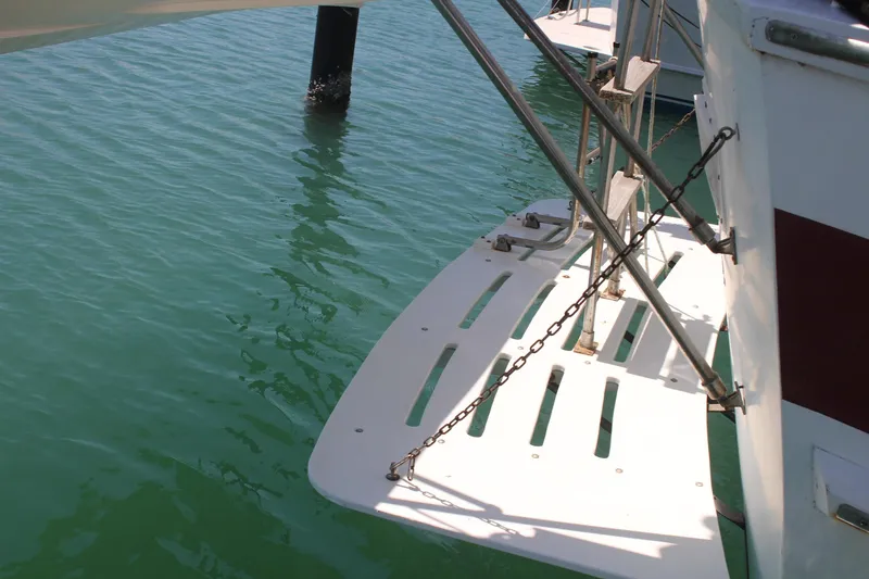 Slide: The Image of Sailboat swim platform on 1981 Endeavour 43, over calm green water. - 3
