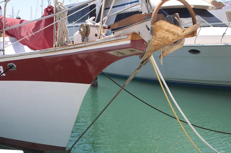 Slide: The Image of Bow of 1981 Endeavour 43 sailboat with anchor, docked in marina. - 4