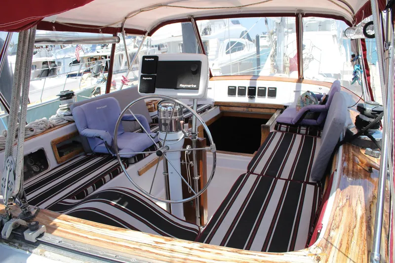 Slide: The Image of Cockpit of 1981 Endeavour 43 sailboat with striped seating and navigation equipment. - 5