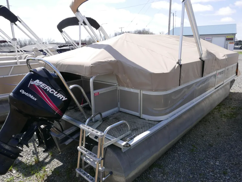 Slide: The Image of 2004 Sylvan Mirage 8522 pontoon boat with Mercury outboard motor, covered and docked. - 3