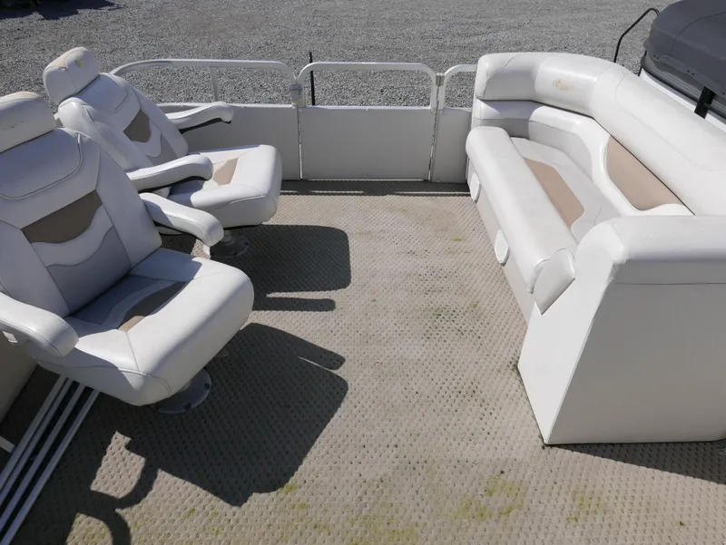 Slide: The Image of 2004 Sylvan Mirage 8522 pontoon boat interior with white seating and carpeted floor. - 7
