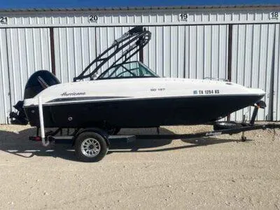 Slide: The Image of 2023 Hurricane SunDeck 187 OB boat on trailer, parked outdoors. - 0