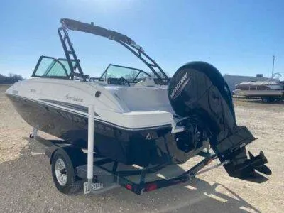 Slide: The Image of 2023 Hurricane SunDeck 187 OB boat on trailer, featuring a Mercury outboard motor. - 3