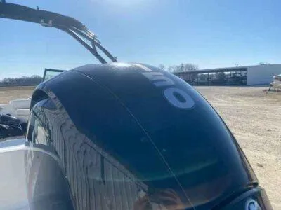 Slide: The Image of 2023 Hurricane SunDeck 187 OB boat with outboard motor in a sunny outdoor setting. - 4