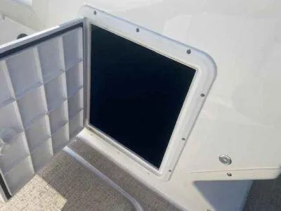 Slide: The Image of Open storage compartment on 2023 Hurricane SunDeck 187 OB boat. - 8