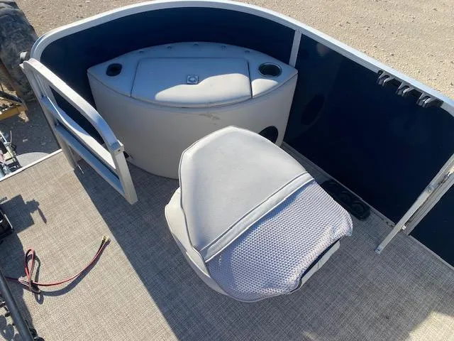 Slide: The Image of 2024 SunCatcher Fusion 322FC boat interior with seating and storage compartment. - 10