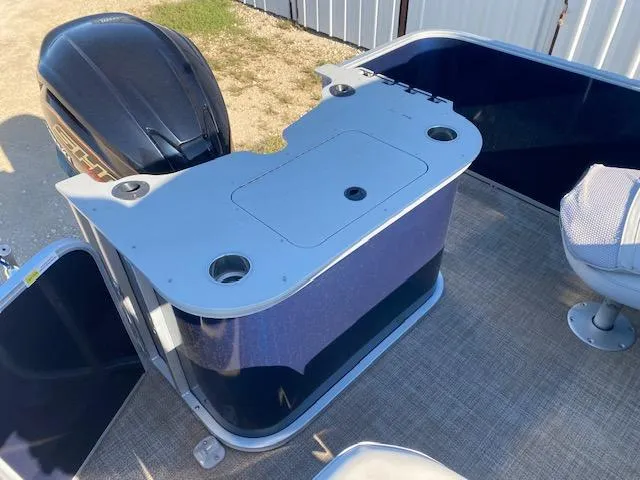 Slide: The Image of 2024 SunCatcher Fusion 322FC boat with motor and seating area. - 12