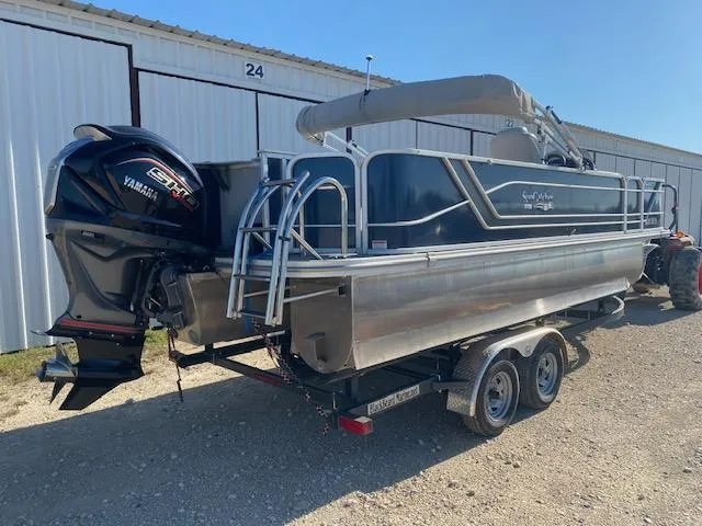 Slide: The Image of 2024 SunCatcher Fusion 322FC pontoon boat with Yamaha engine, parked on a trailer. - 5