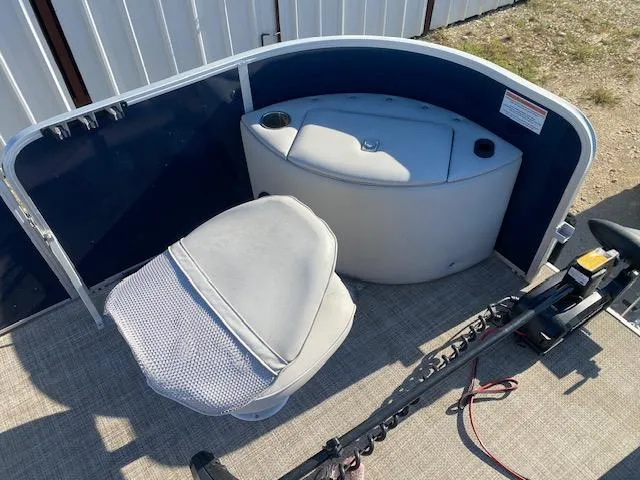 Slide: The Image of 2024 SunCatcher Fusion 322FC boat interior with seating and storage compartment. - 9