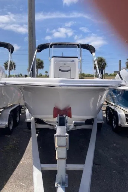 The Image of 2025 Sea Pro 202 Center Console boat on trailer, parked outdoors. - 0