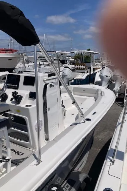 Slide: The Image of 2025 Sea Pro 202 Center Console boat docked, featuring modern controls and dual engines. - 2