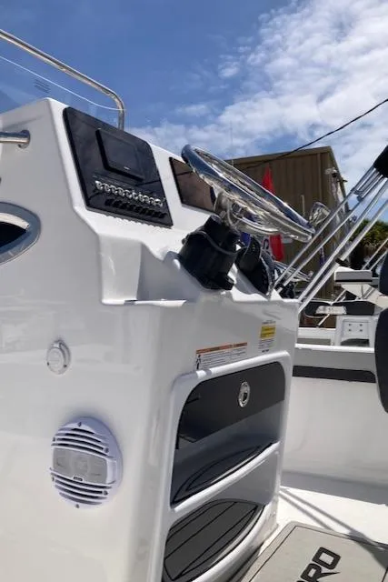 Slide: The Image of 2025 Sea Pro 202 Center Console boat dashboard with steering wheel and controls. - 5