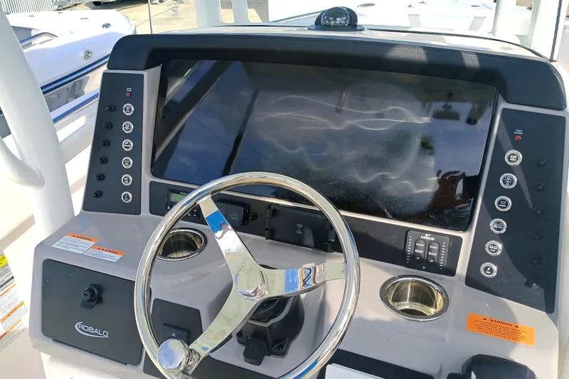 Slide: The Image of 2025 Robalo R230 Center Console dashboard with steering wheel and control panel. - 17