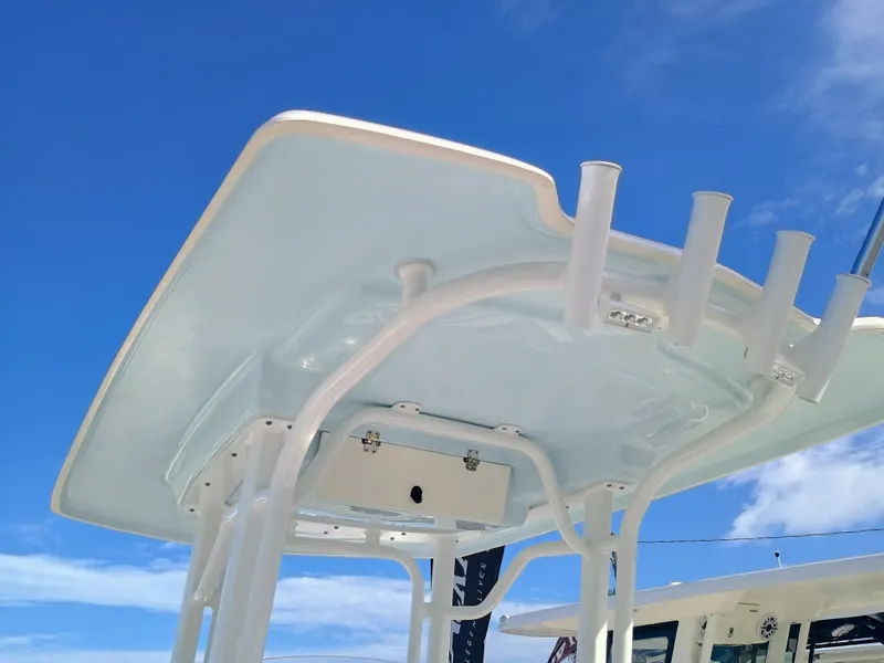 Slide: The Image of 2025 Robalo R230 Center Console boat's T-top against a clear blue sky. - 21