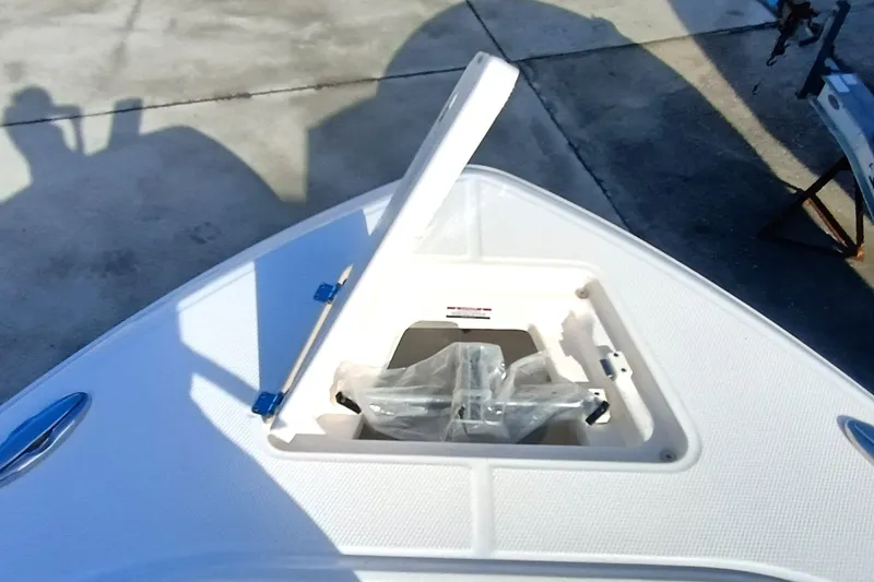 Slide: The Image of 2025 Robalo R230 Center Console boat with open storage compartment on deck. - 7