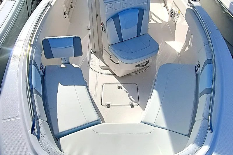 Slide: The Image of 2025 Robalo R230 Center Console boat interior with blue and white seating. - 8