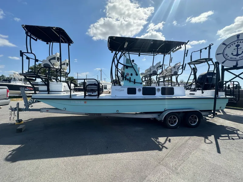 Slide: The Image of 2024 Shallow Master 270 SMC boat on trailer under sunny sky. - 12