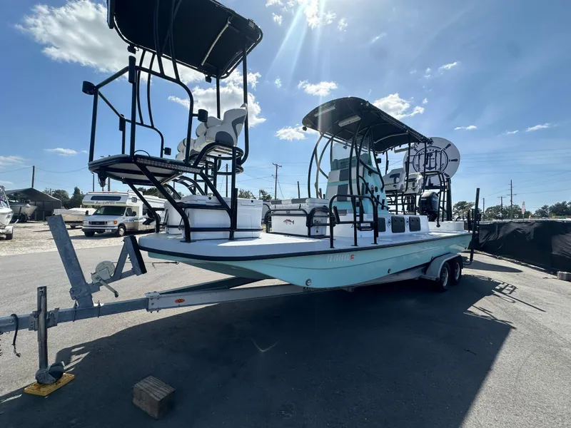 Slide: The Image of 2024 Shallow Master 270 SMC boat on trailer under sunny sky. - 13