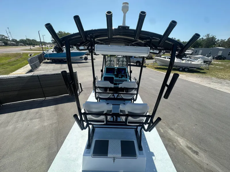 Slide: The Image of 2024 Shallow Master 270 SMC boat with rod holders, parked on a sunny day. - 15