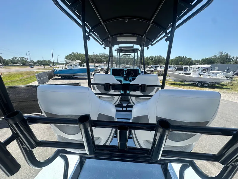 Slide: The Image of 2024 Shallow Master 270 SMC boat interior with white seating and rod holders. - 16
