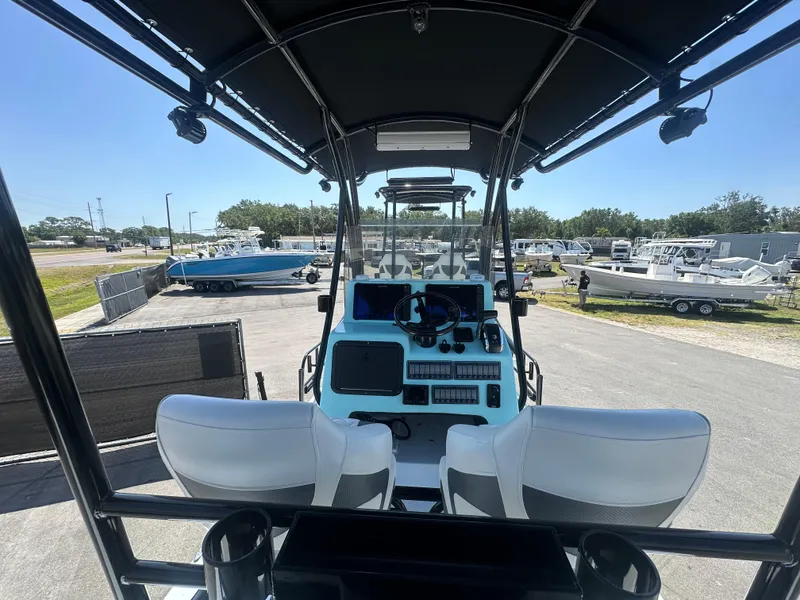 Slide: The Image of 2024 Shallow Master 270 SMC boat interior with dual seats and control panel. - 17