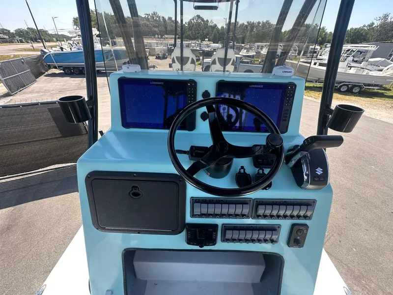 Slide: The Image of 2024 Shallow Master 270 SMC boat console with steering wheel and navigation screens. - 18