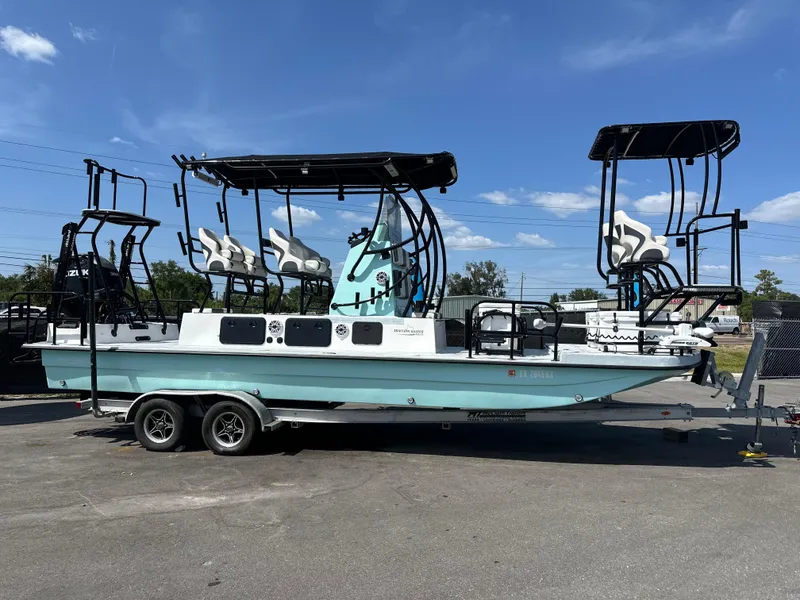 Slide: The Image of 2024 Shallow Master 270 SMC boat on trailer under clear blue sky. - 2