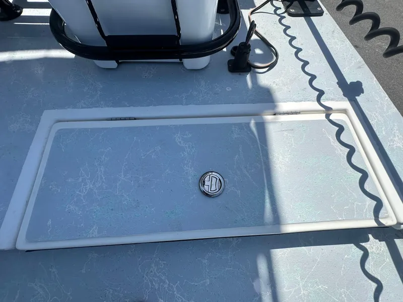 Slide: The Image of 2024 Shallow Master 270 SMC boat deck with storage compartment and latch. - 27