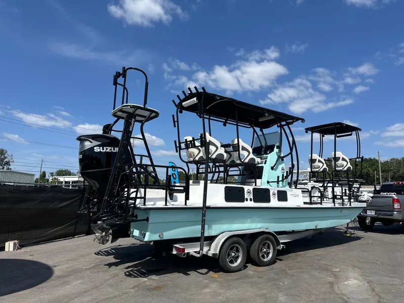 Slide: The Image of 2024 Shallow Master 270 SMC boat on trailer under blue sky. - 4