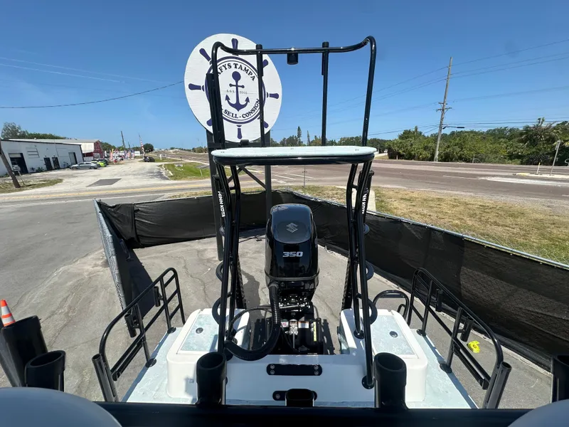 Slide: The Image of 2024 Shallow Master 270 SMC boat with powerful engine, docked outdoors under clear blue sky. - 44