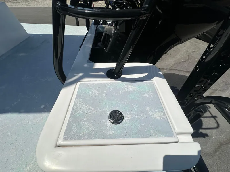 Slide: The Image of 2024 Shallow Master 270 SMC boat deck with textured surface and black railing. - 46