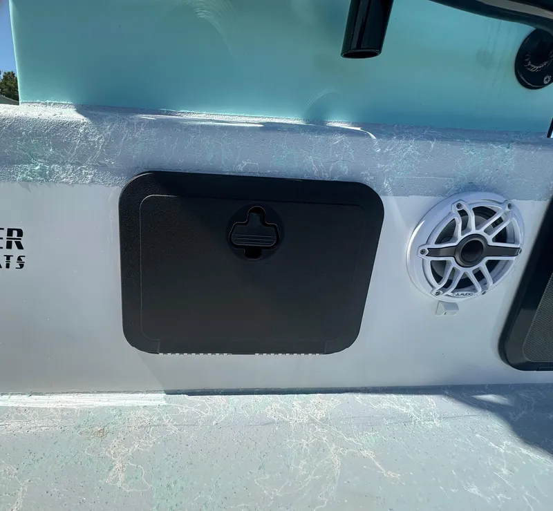 Slide: The Image of 2024 Shallow Master 270 SMC boat interior with speaker and storage compartment. - 48