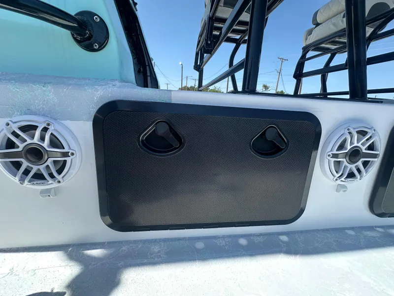 Slide: The Image of 2024 Shallow Master 270 SMC boat speakers and storage compartment on deck. - 49