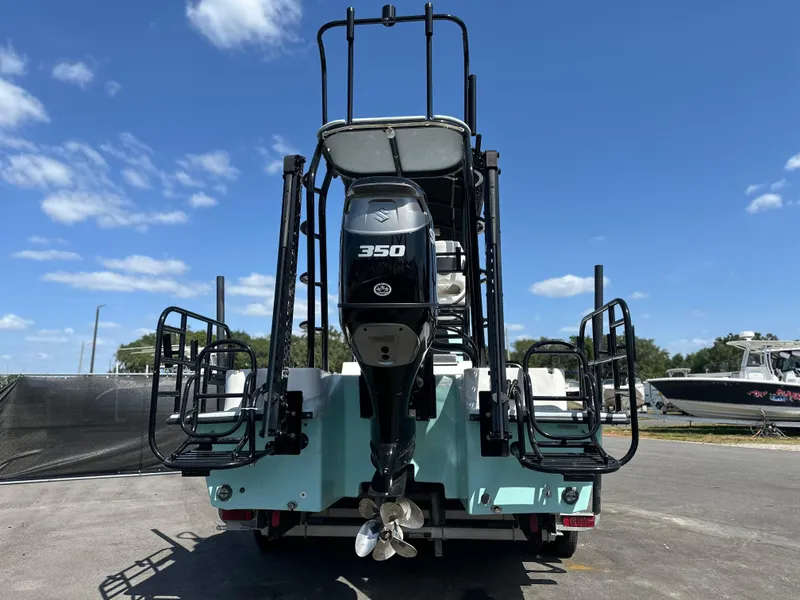 Slide: The Image of 2024 Shallow Master 270 SMC boat with powerful 350 engine, rear view under clear sky. - 6