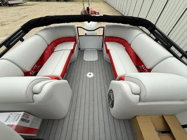 Slide: The Image of 2025 SunCatcher Elite 324 RC pontoon boat interior with gray and red seating. - 10