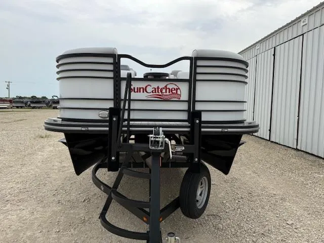 Slide: The Image of 2025 SunCatcher Elite 324 RC pontoon boat on trailer, front view. - 2