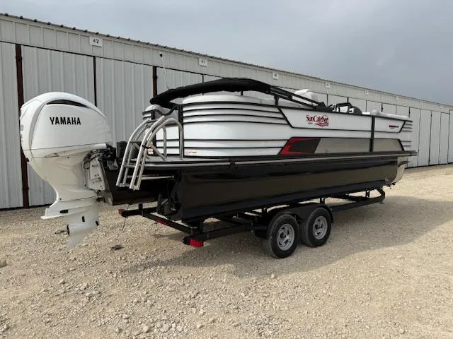 Slide: The Image of 2025 SunCatcher Elite 324 RC pontoon boat on trailer, featuring Yamaha outboard motor. - 3