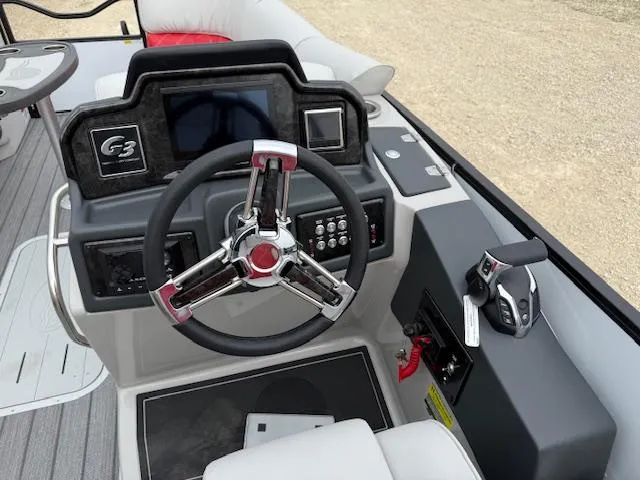 Slide: The Image of 2025 SunCatcher Elite 324 RC boat dashboard with steering wheel and control panel. - 5