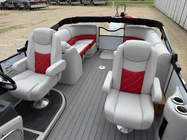 Slide: The Image of 2025 SunCatcher Elite 324 RC boat interior with plush seating and red accents. - 7