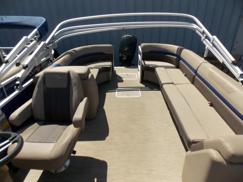 Slide: The Image of 2022 Bennington SX 23 Quad Bench boat interior with beige seating and steering console. - 12