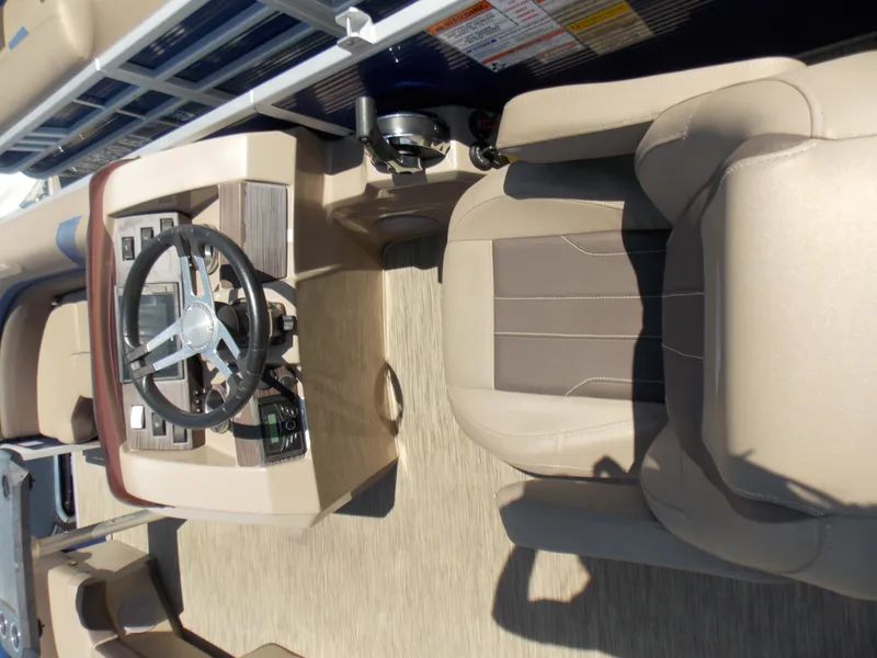 Slide: The Image of 2022 Bennington SX 23 Quad Bench boat interior with steering wheel and seating. - 13