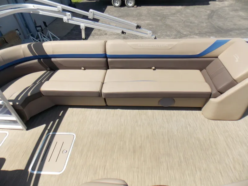 Slide: The Image of 2022 Bennington SX 23 Quad Bench with beige seating and blue accents. - 14