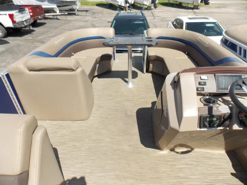 Slide: The Image of 2022 Bennington SX 23 Quad Bench boat interior with beige seating and control panel. - 15