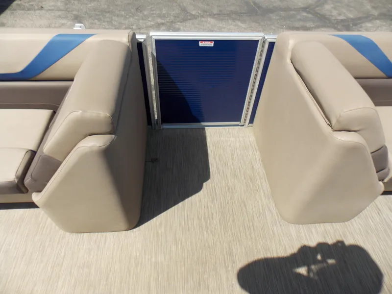 Slide: The Image of 2022 Bennington SX 23 Quad Bench interior with beige seating and blue accents. - 16
