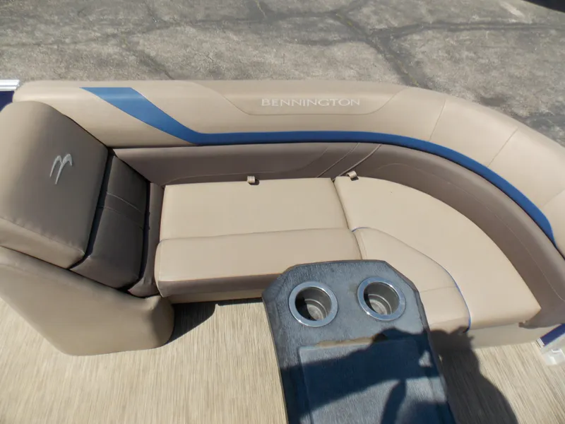 Slide: The Image of Bennington SX 23 Quad Bench 2022 with beige and blue seating, featuring cup holders. - 17