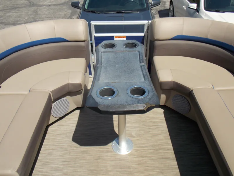 Slide: The Image of 2022 Bennington SX 23 Quad Bench interior with beige seating and cup holders. - 20