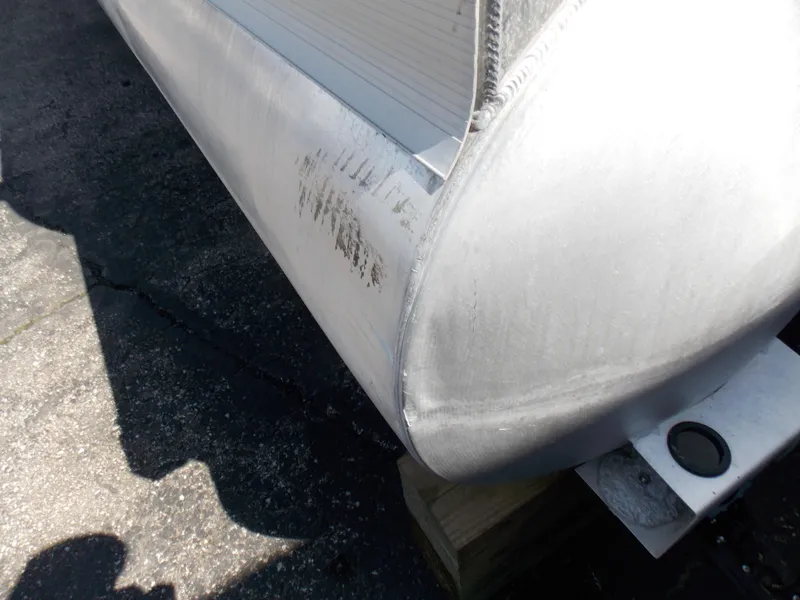 Slide: The Image of 2022 Bennington SX 23 Quad Bench pontoon with visible scuff marks on the side. - 22