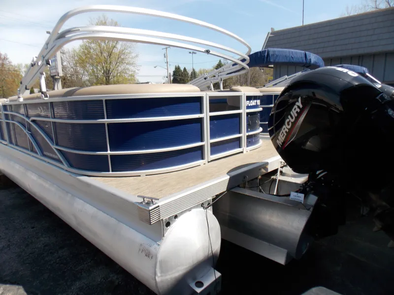 Slide: The Image of 2022 Bennington SX 23 Quad Bench pontoon boat with Mercury outboard motor. - 5