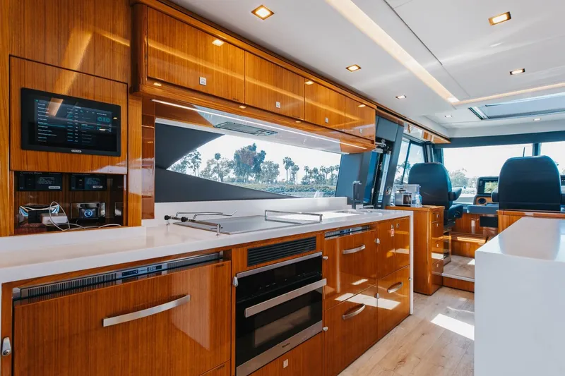 Slide: The Image of Luxurious interior of 2022 Riviera 645 SUV yacht with modern kitchen amenities. - 10